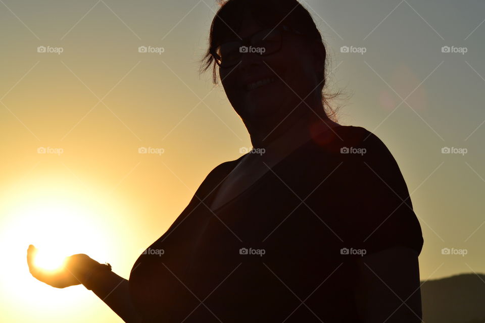 female holding the sun