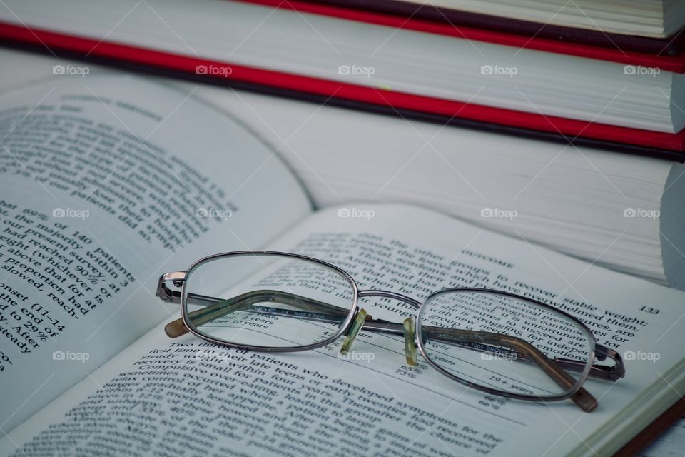 Reading glasses resting on a book