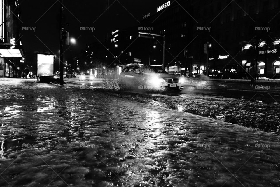 Helsinki, Finland - 9 January 2012:  Car driving on Mannerheimintie in the center of Helsinki in wet winter weather.