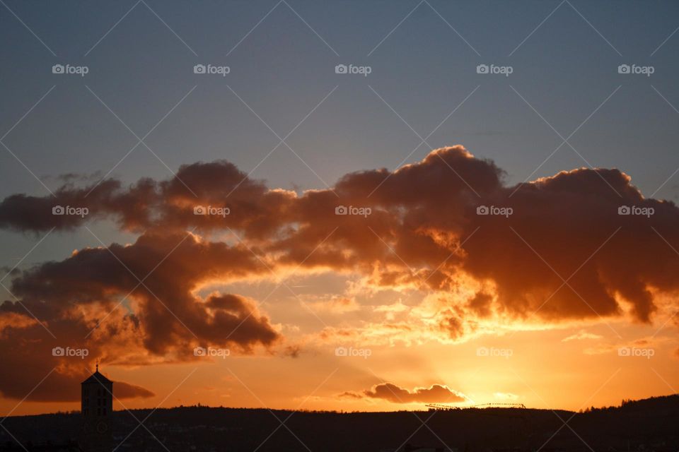 Sunset in the sky with illuminated clouds.