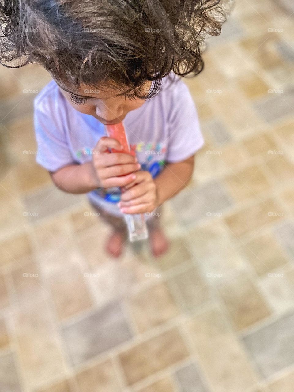 Toddler girl eating popsicle, little girl enjoying a summertime treat, summertime treat for children, popsicles in the summer 