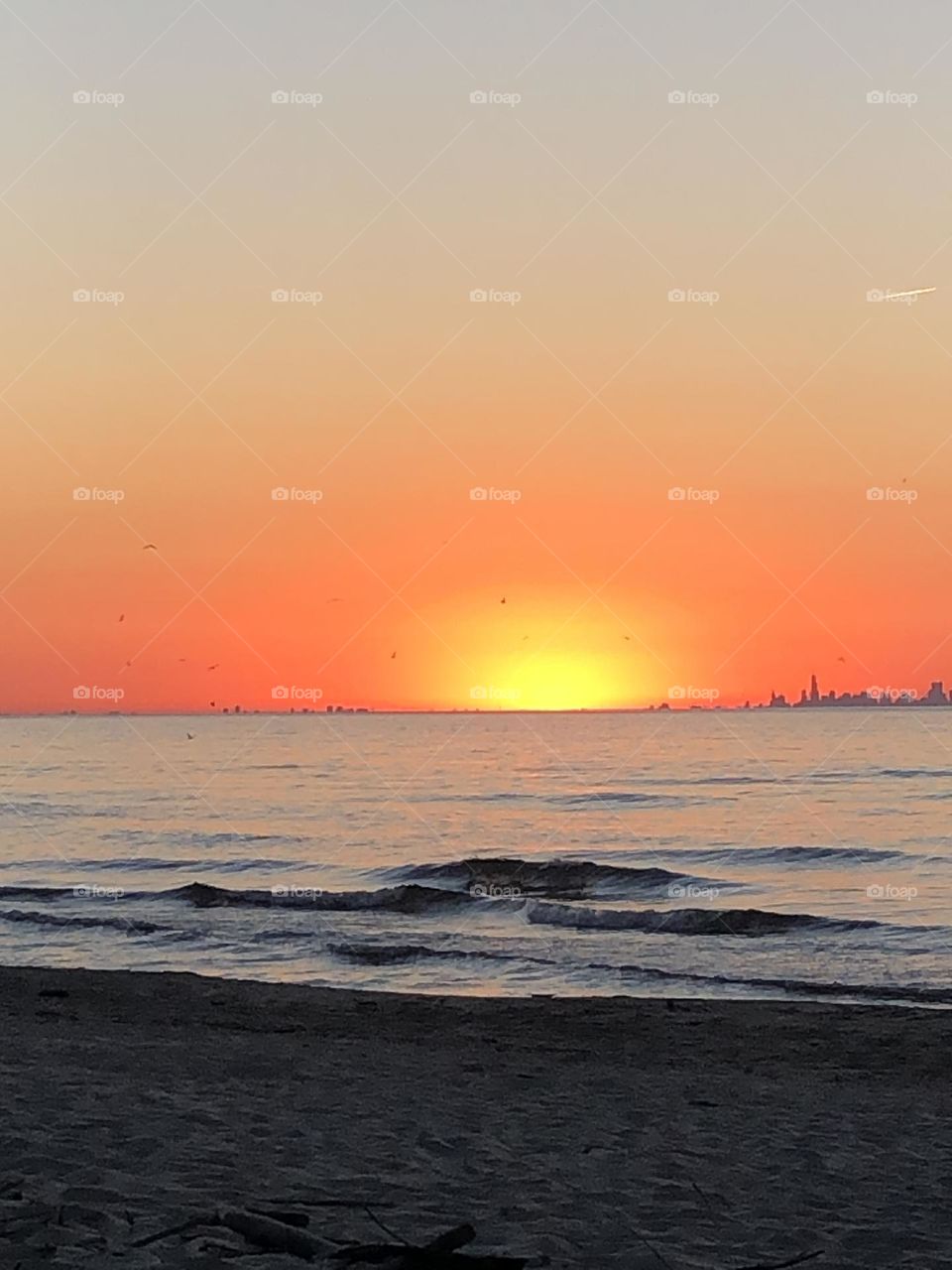 Warm beautiful day at the beach with a brilliant warm yellow sun and radiating an orange glow! 