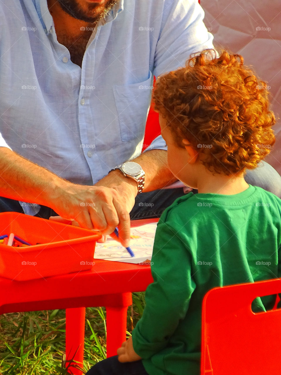 The child paints and colors