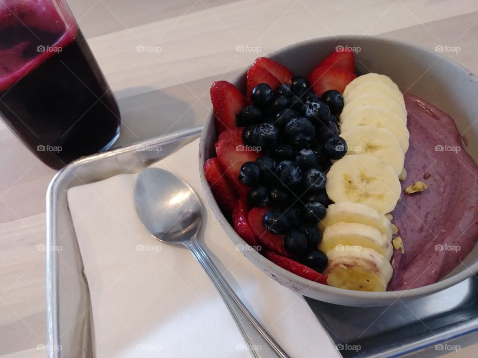 Acai fruit bowl with a side of beet juice