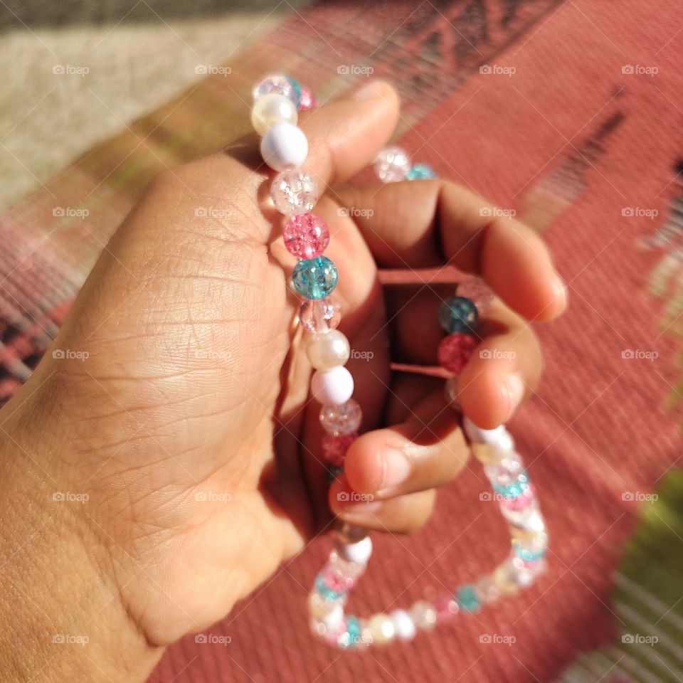 reflection of sunrays on beads and shadow