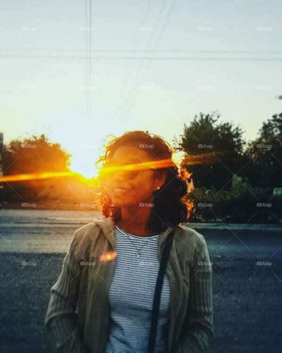 Sunbeams illuminating a girl on the road