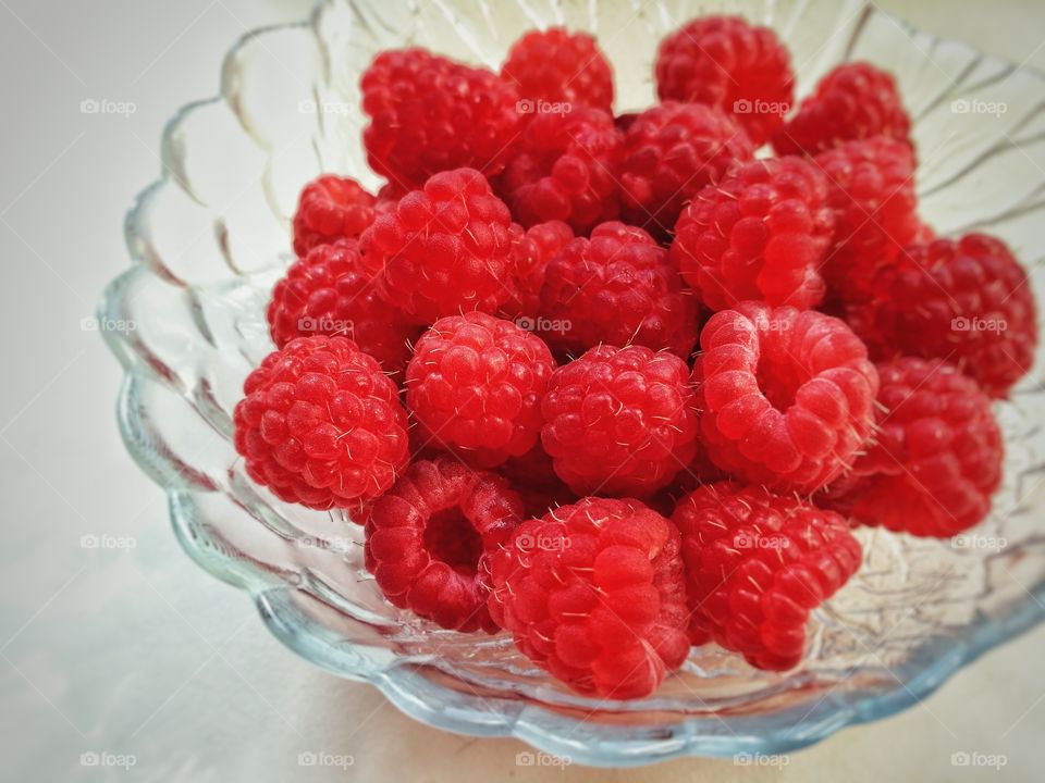 Raspberries in a glass plate
