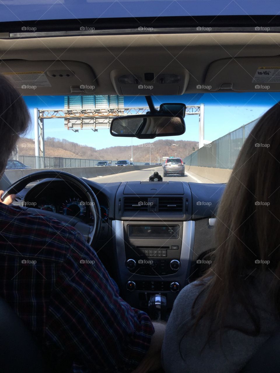 The view of driving down a bridge in the backseat