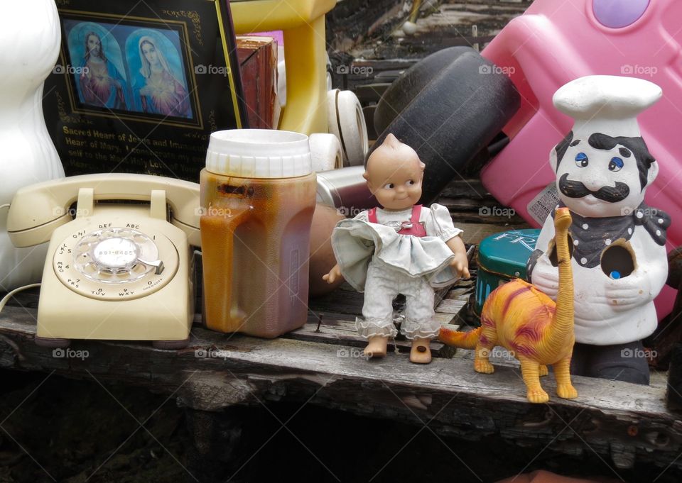 Kewpie doll. A phone, kewpie doll, dinosaur and a chef