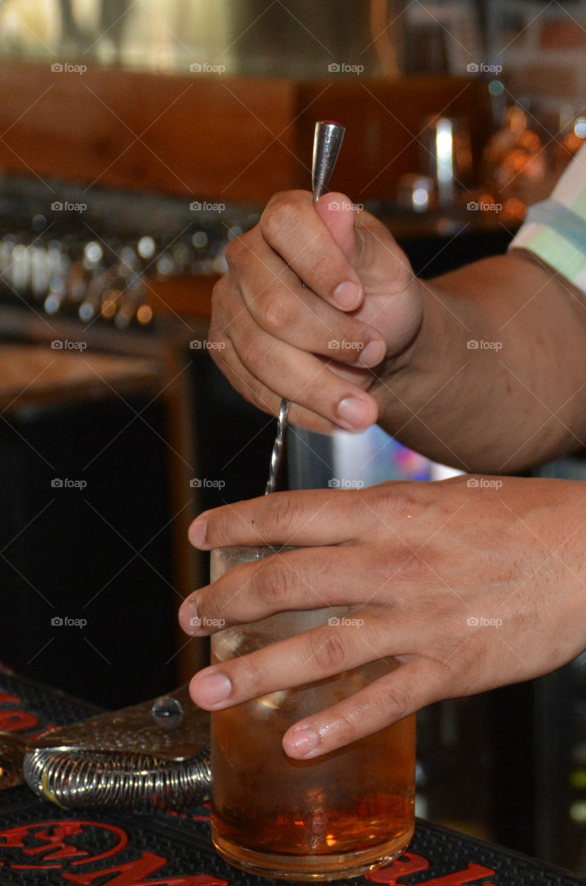 A bartender making a drink in a bar