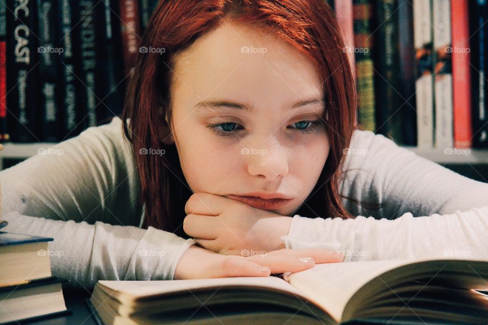 Teenage girl reading book
