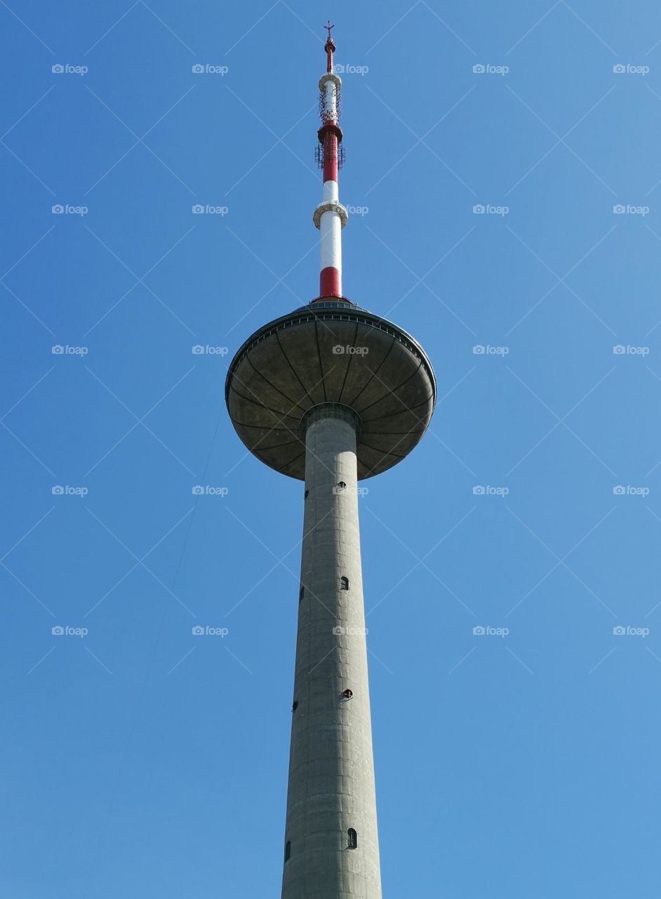 Unusual shooting angle. Shooting from below. Down up. From the ground up... Vilnius TV tower. Blue sky and skyscrapers.