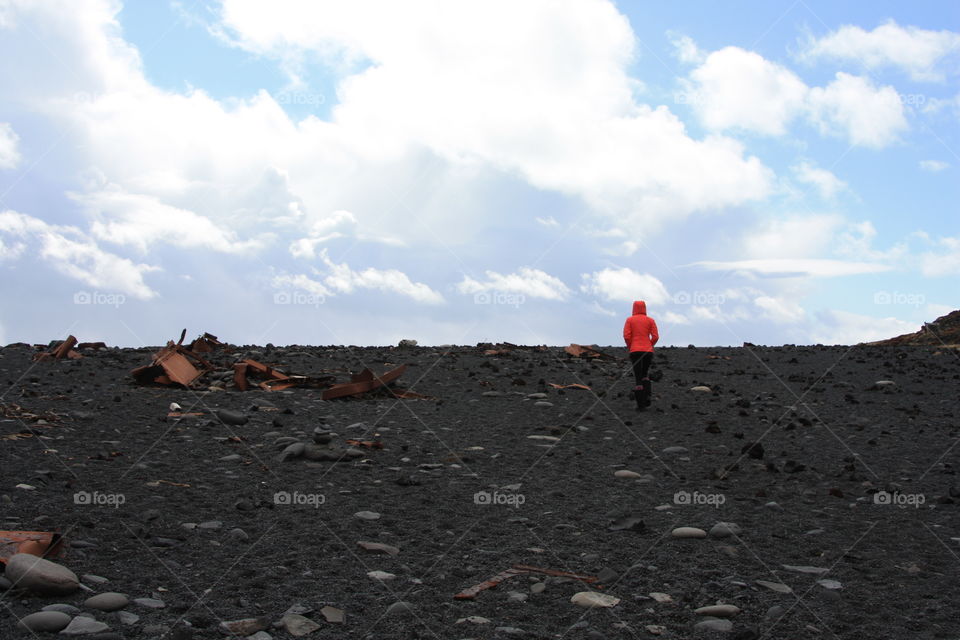 Adventuring through the debris of an old plane wreck on a black lava beach in Iceland 