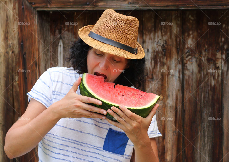 A woman eating watermelon slice