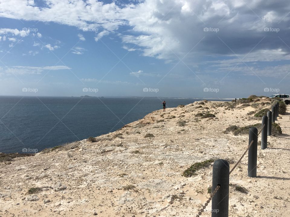 Ocean view from a sea cliff, south Australia Coffin Bay national
Park area, man on distance on cliff edge 