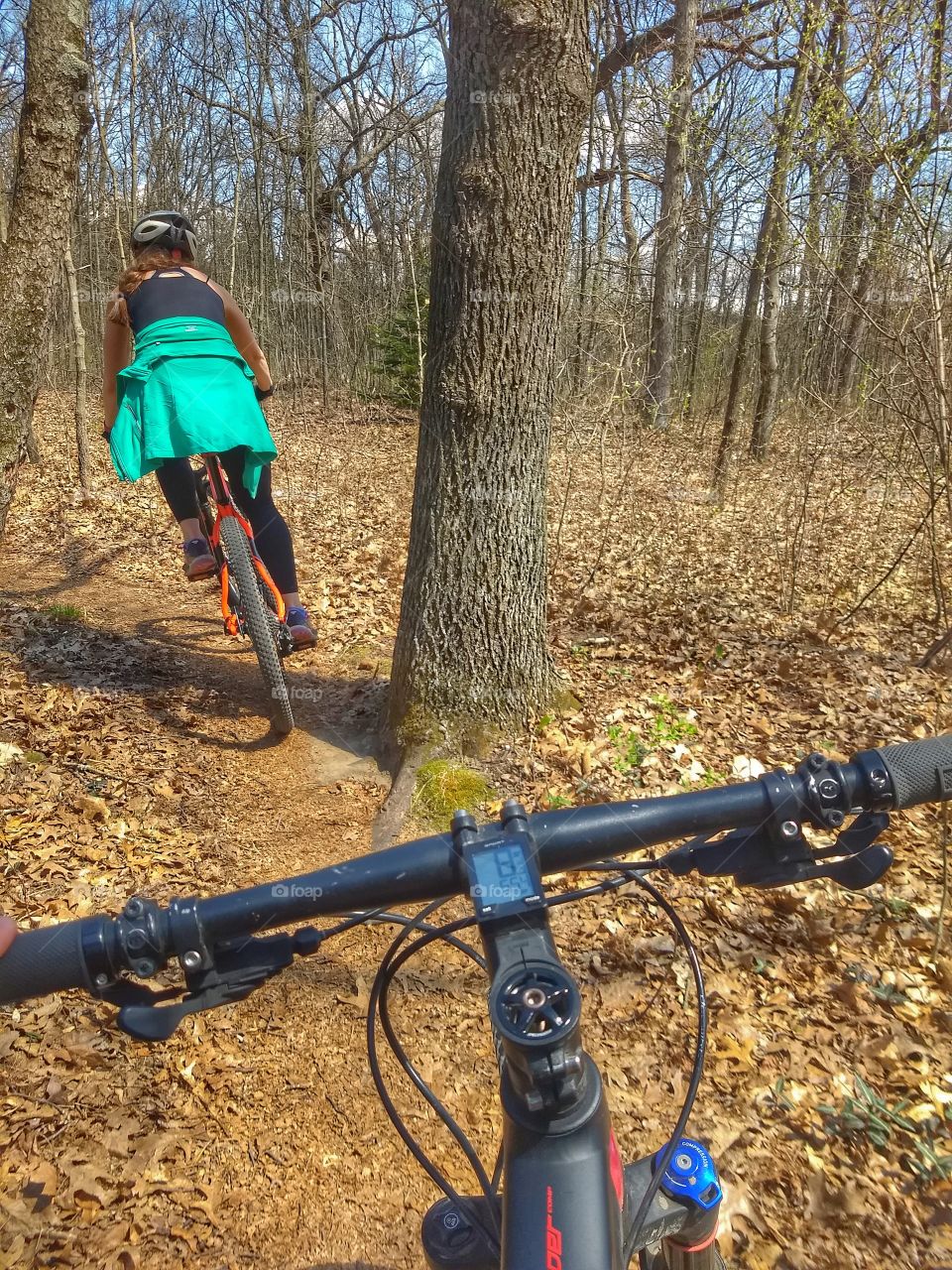 Following a beautiful woman on a mountain bike