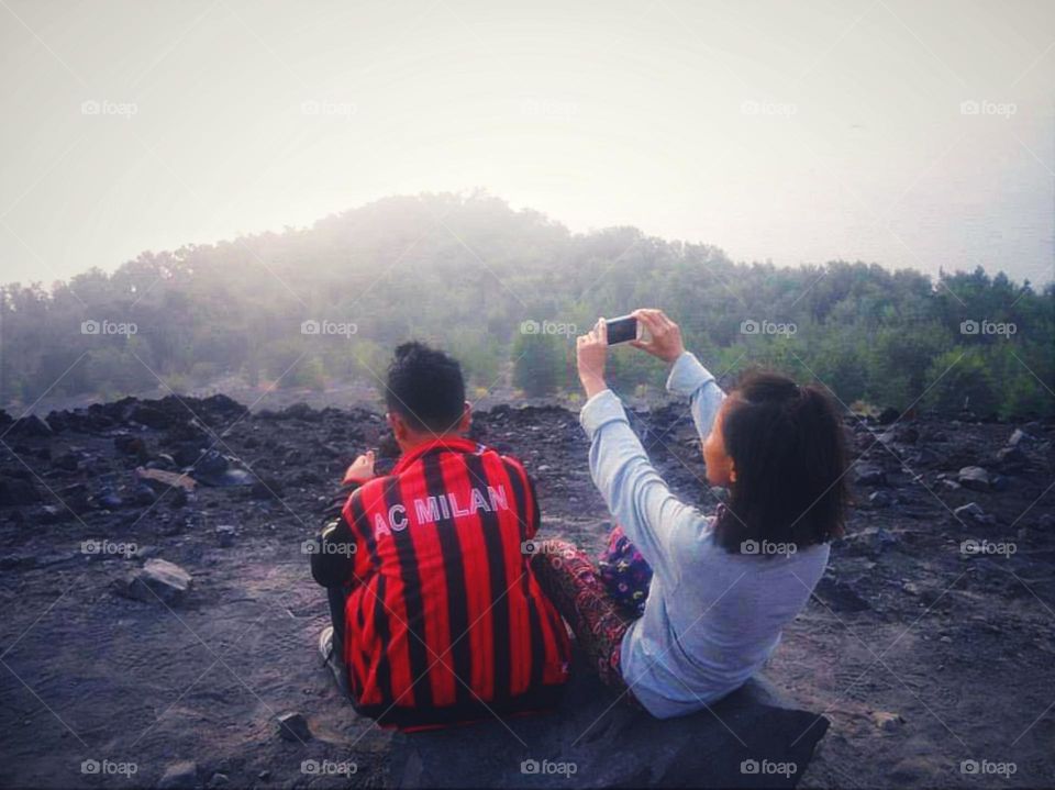 Boy and girl enjoying a view and taking pictures...