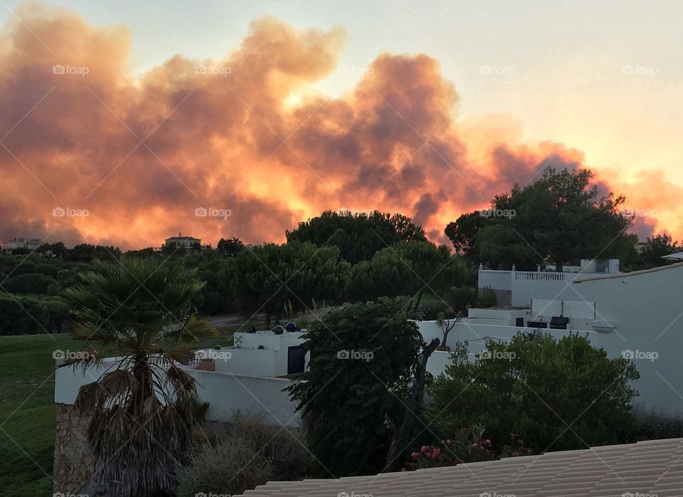 Big fire approaching houses at evening