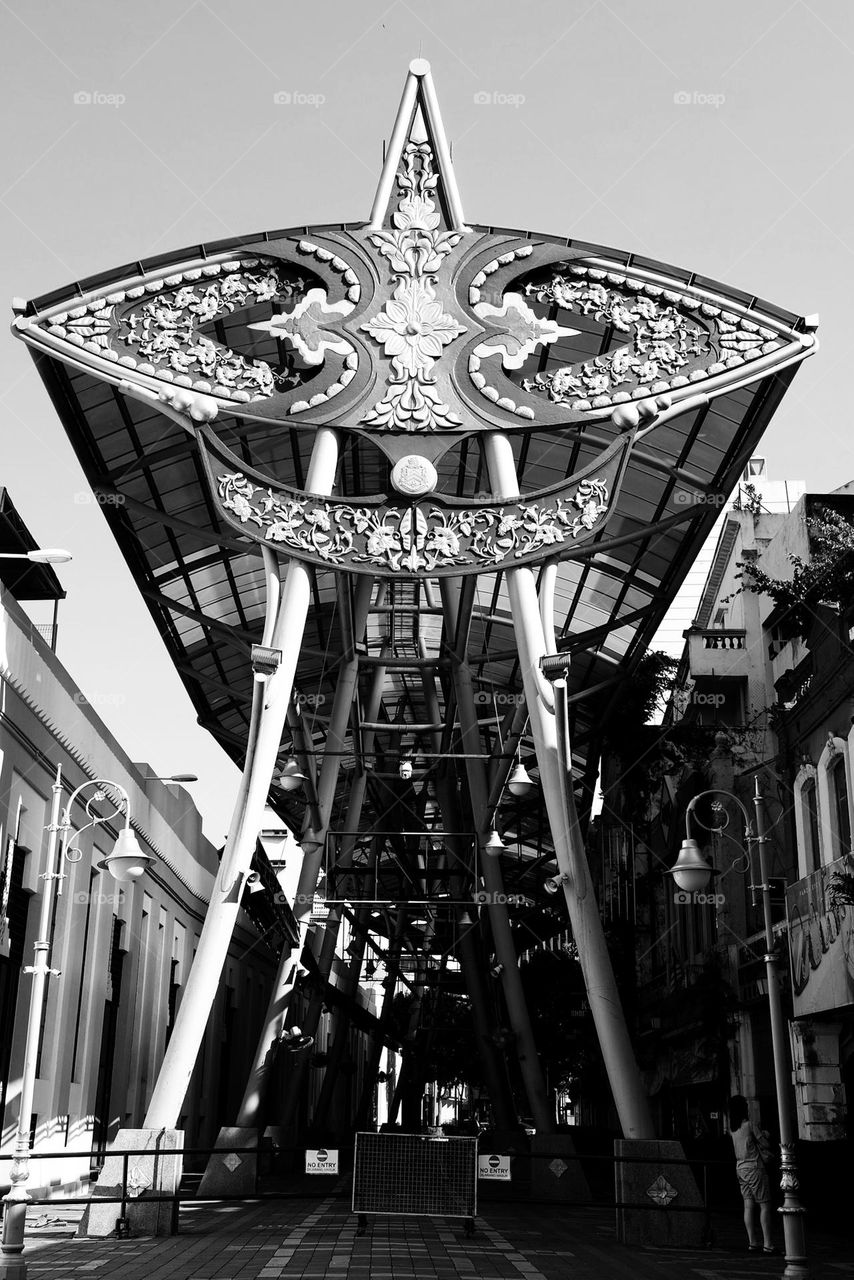 Kasturi Walk street market in Chinatown. Main entrance with giant pewter Wau Bulan (national icon), a Malay kite which resembles a butterfly.