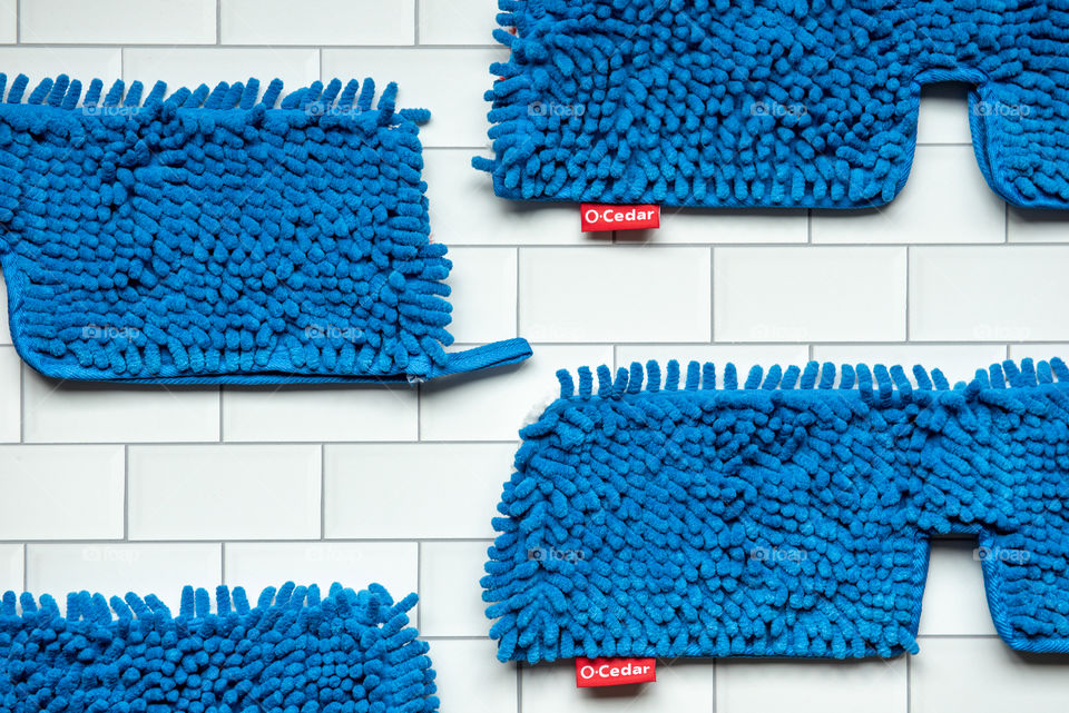 Flat lay of O-Cedar microfiber mop head refills on a tile floor