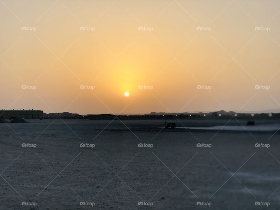 This is a sunset over oman , just about to go to bed and this was the view , hot and sandy place