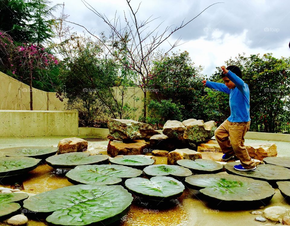 Little boy standing on stone