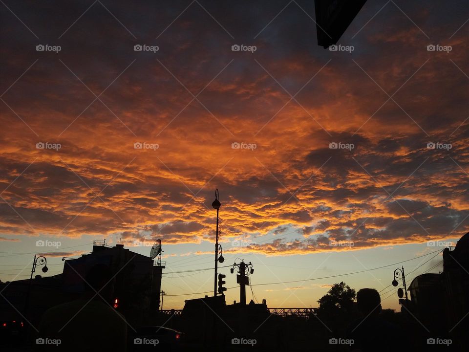 on amazing sunset and orange clouds in the city centre