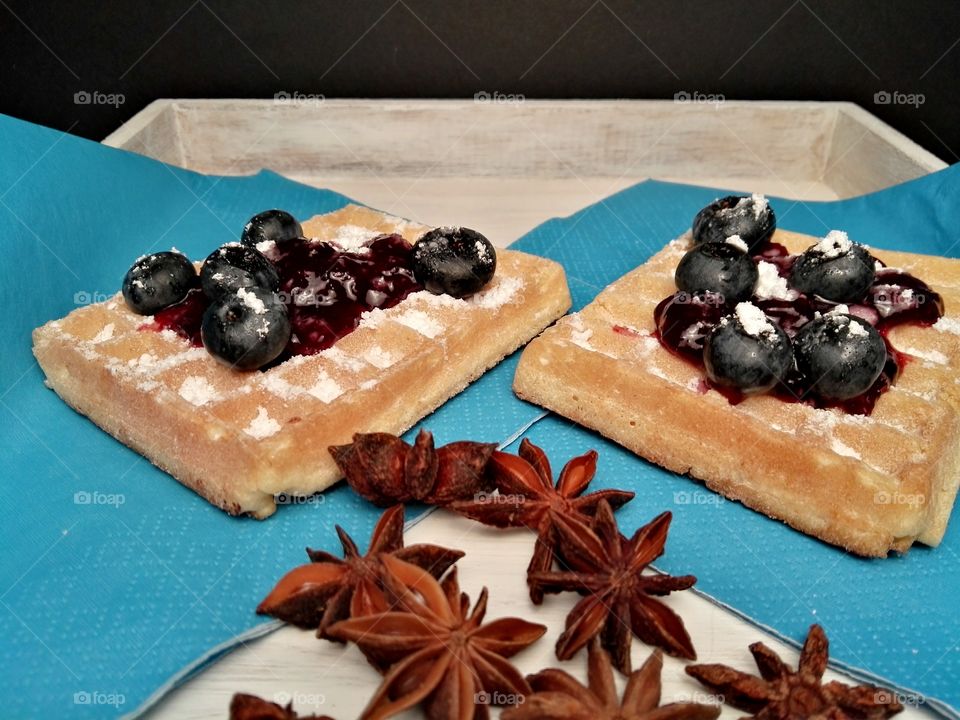 Healthy Christmas sweets with fruits, jam and dark chocolate on a rustic background