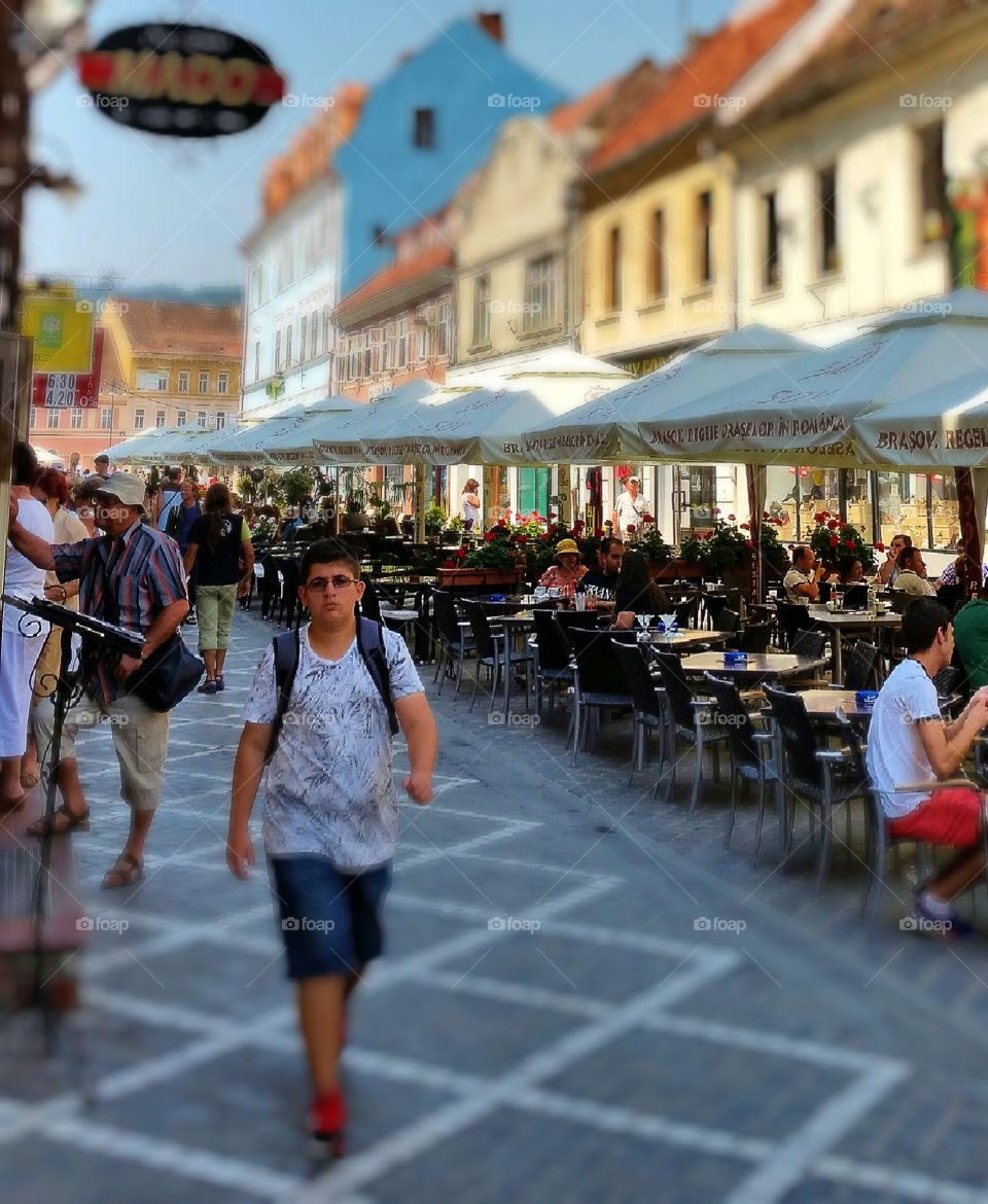 People on old town street of Brasov, Romania