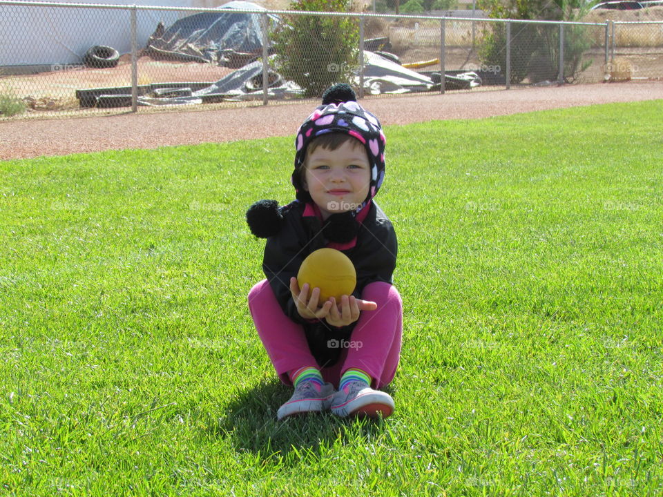 child's play. sitting on the softball field playing ball