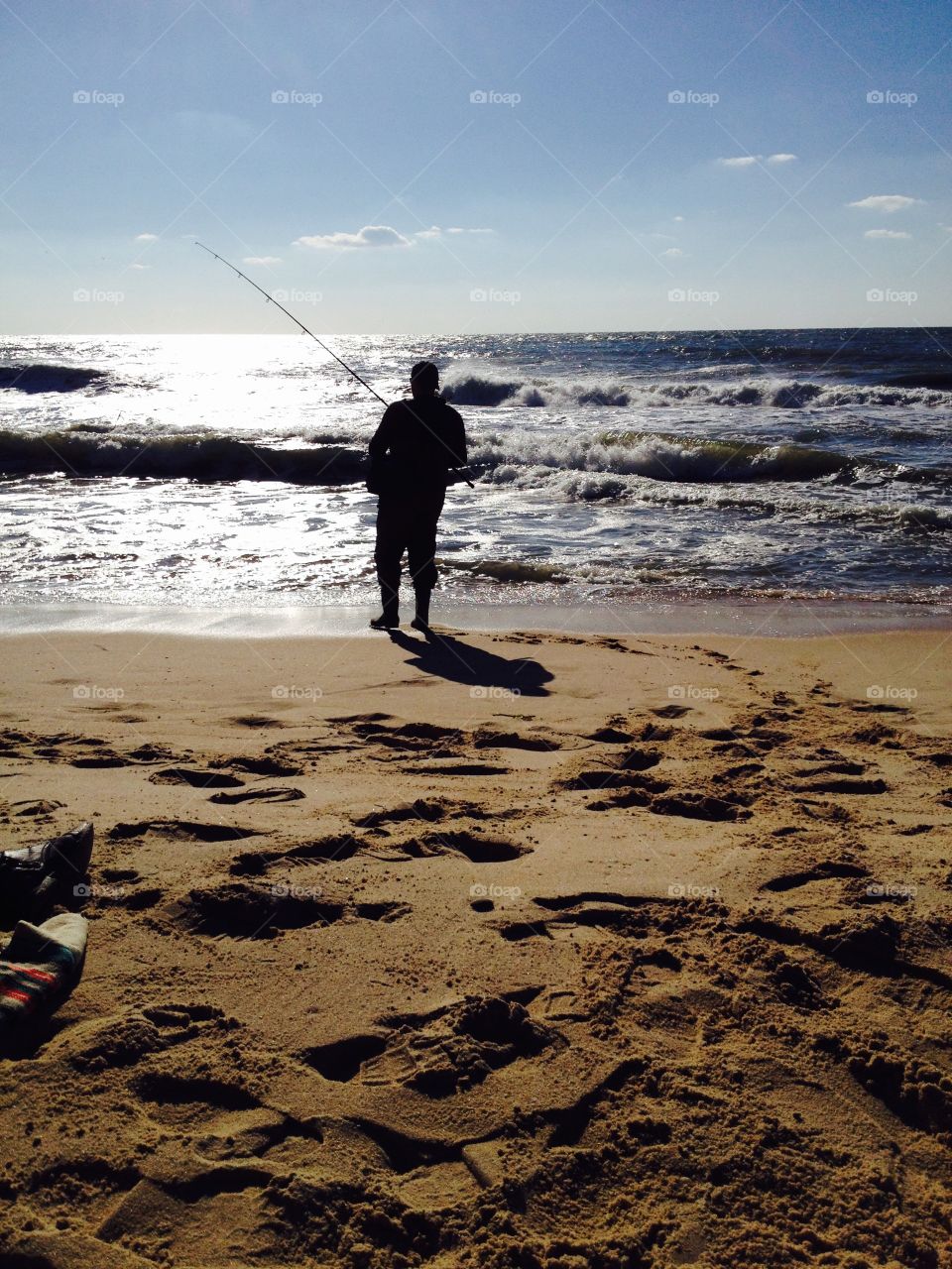Fisherman. Only man on the beach fishing