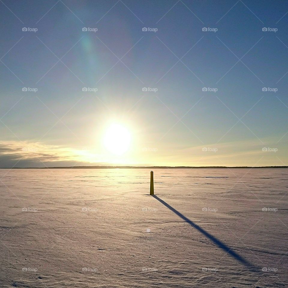 Frozen search in sunset. Frozen search with navigation mark in sunset 
