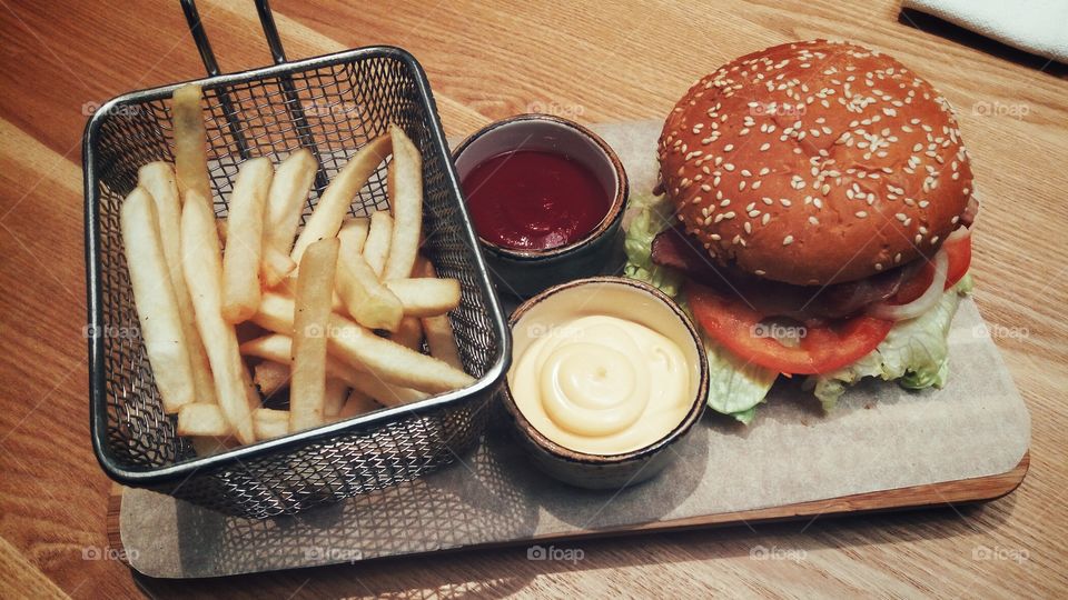 high angle view burger and fries on wood desk