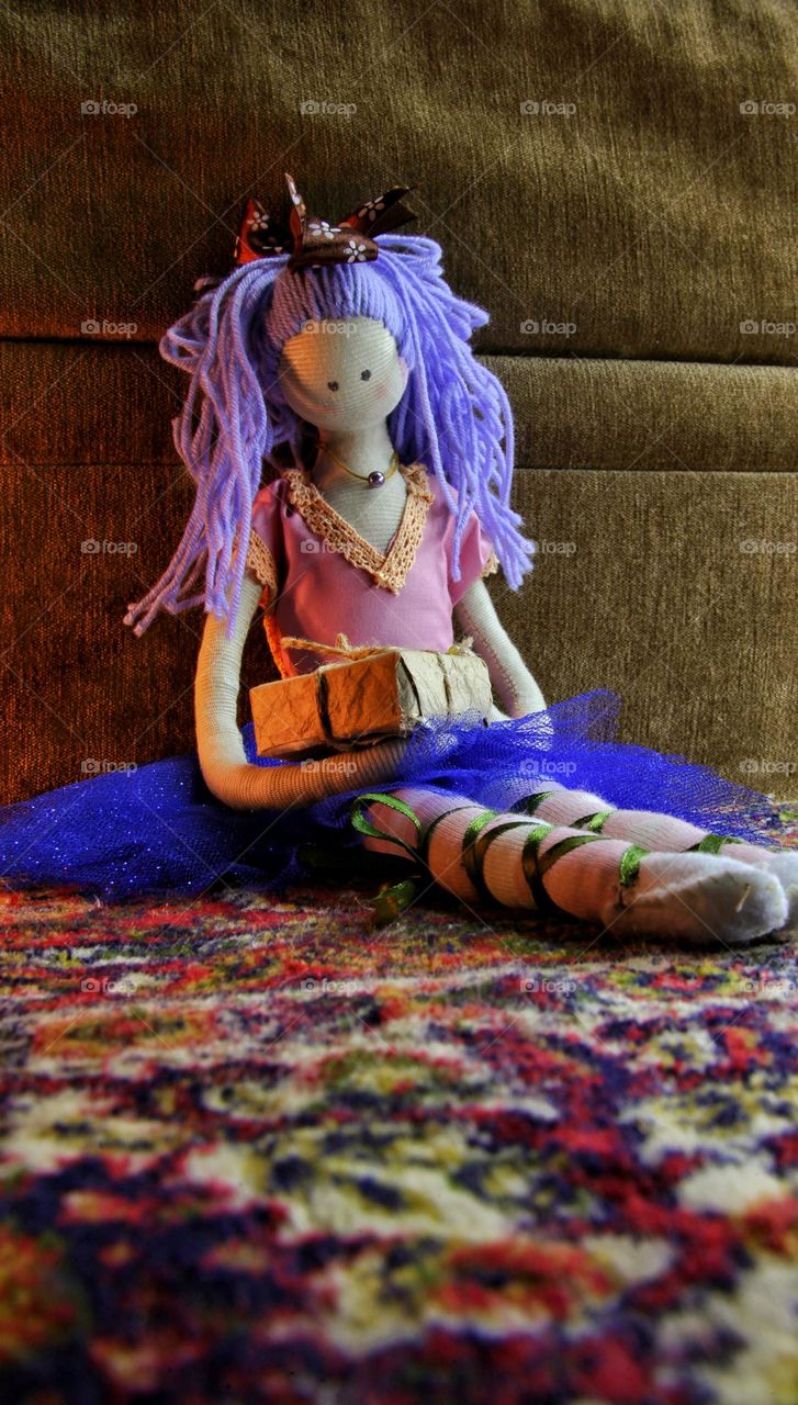 rag doll holding a gift in her hands