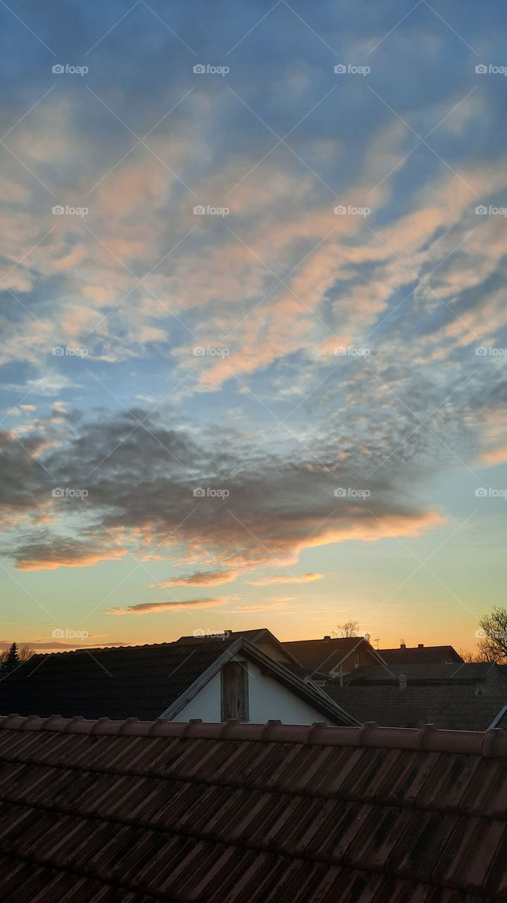 roofs under orange sky