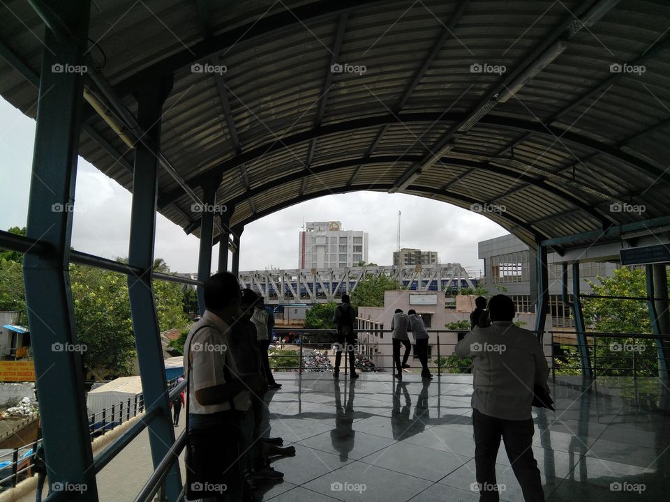 people are waiting here for some cold wind on this path way to Mumbai metro ... metropolitan..