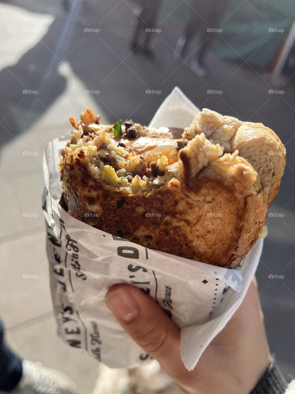 A market toastie made fresh with some bites out of it 