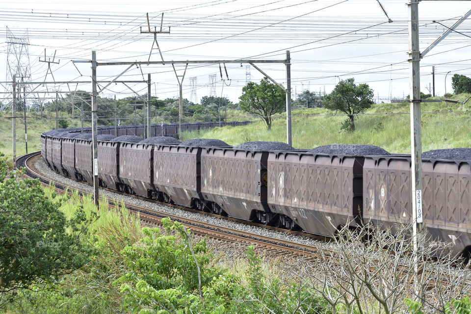 A Fully Loaded Train Snakes Its Way Through To Deliver Coal