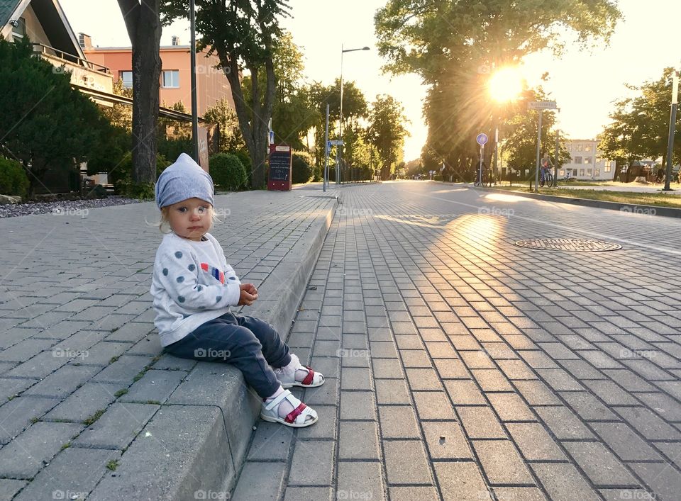 Girl and sunset in the village 