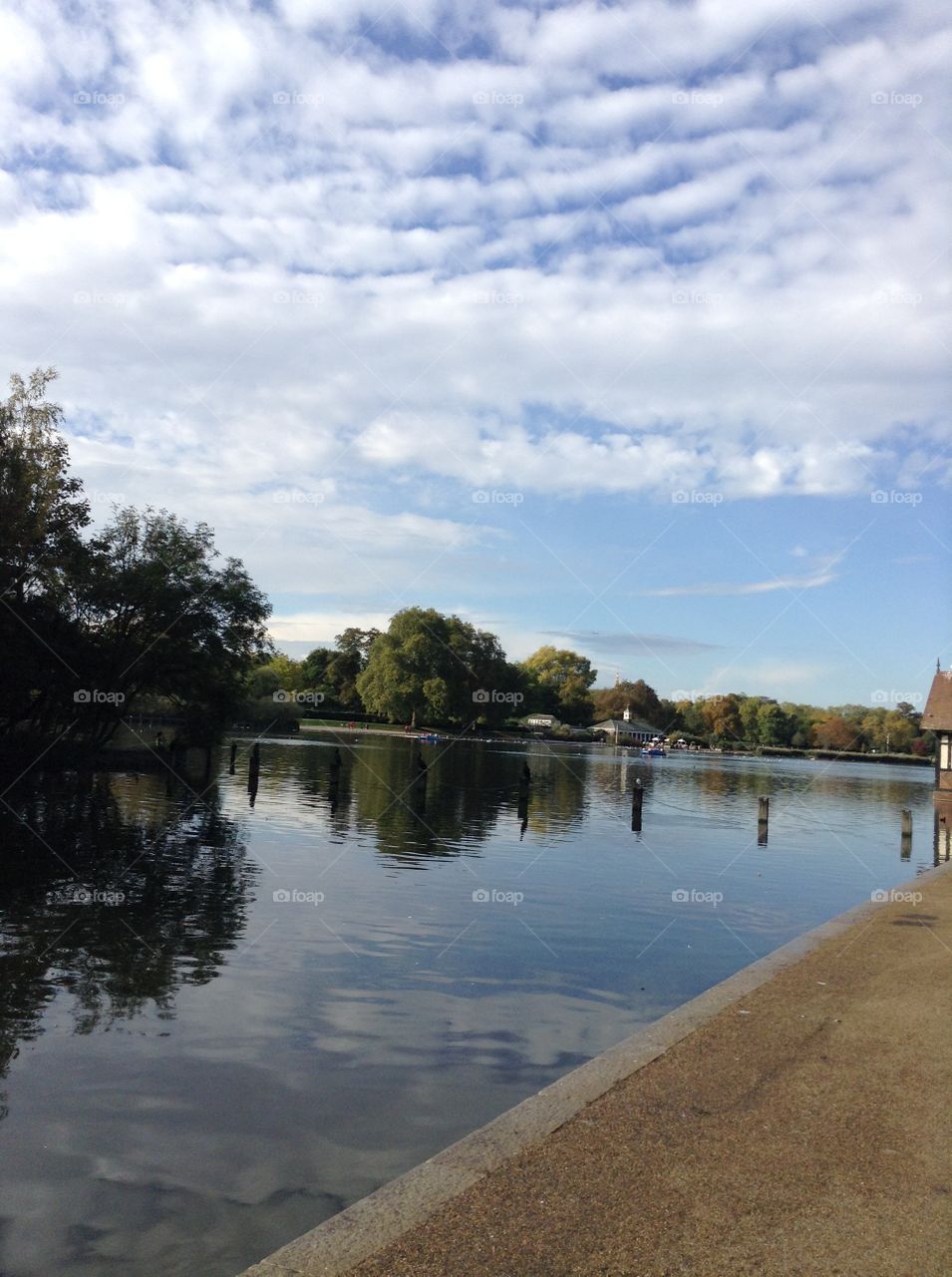 The reflection of the green trees and the blue sky on the water makes a lovely view