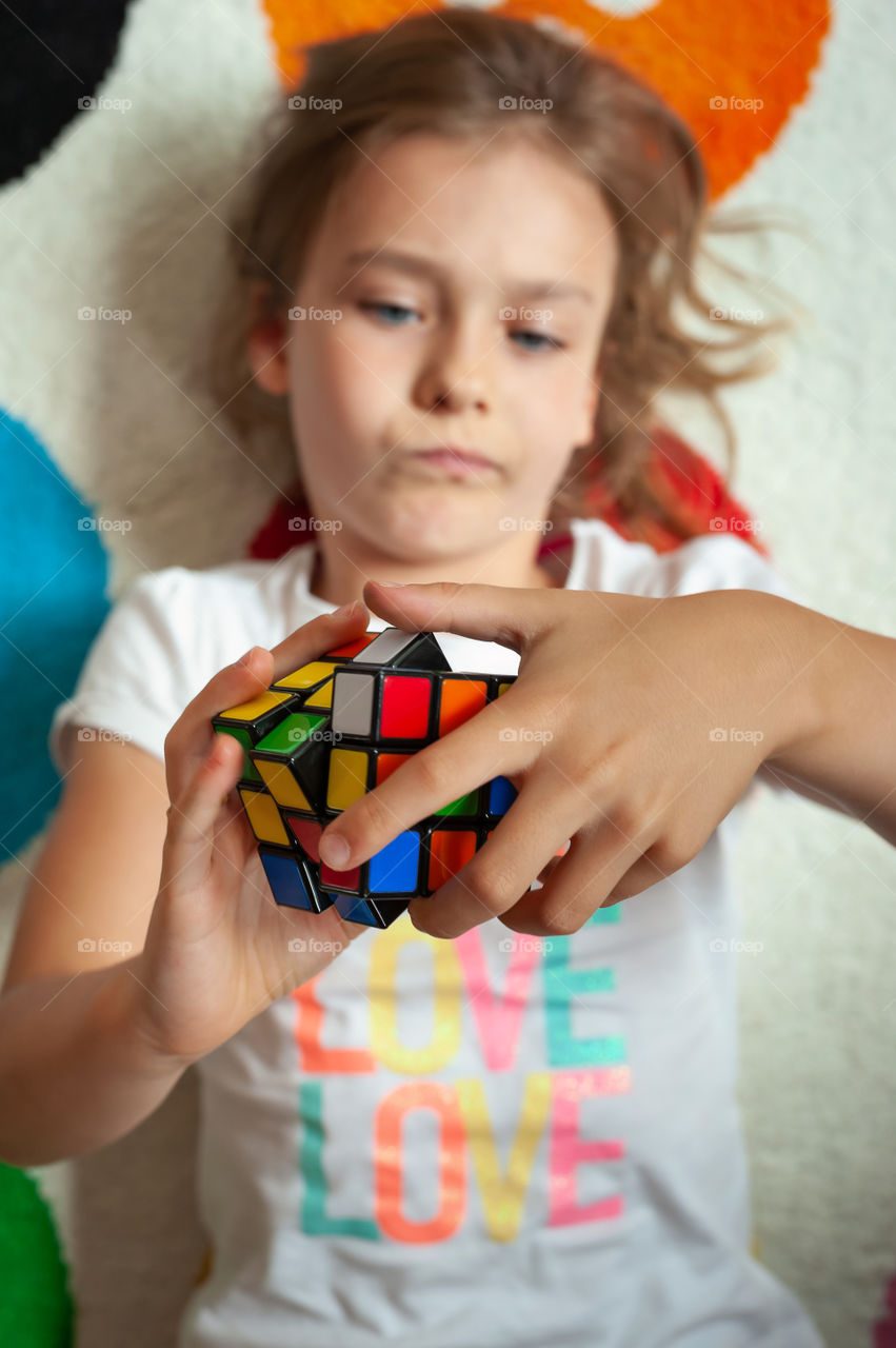 Little girl with Rubik's Cube.