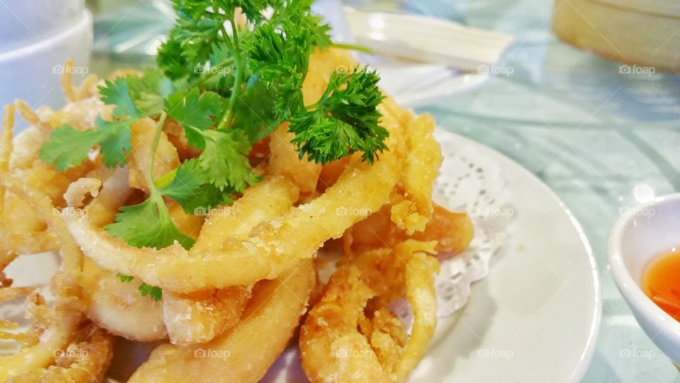Squid deep fried in salt, pepper and chilli. This is a very popular Chinese dim sum or yum cha dish.