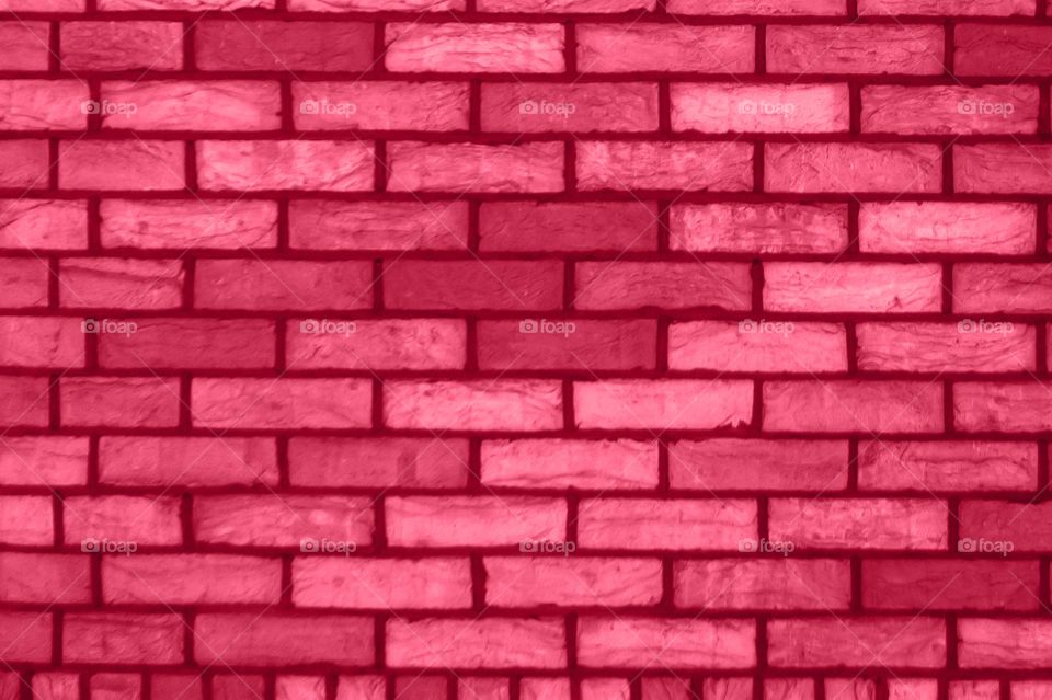 Color of the year 2023 Viva Magenta Pantone according to the institute. Brick wall mockup copy space. Unconventional Shade for an Unconventional Time