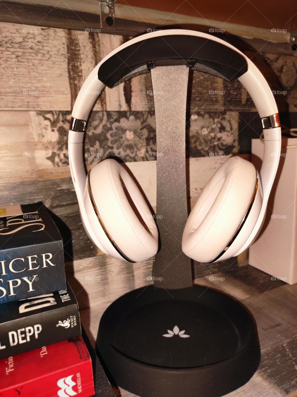 Headphones /White Beats studio headphones on a headphone stand /Headphones for listening to music /Beats headphones