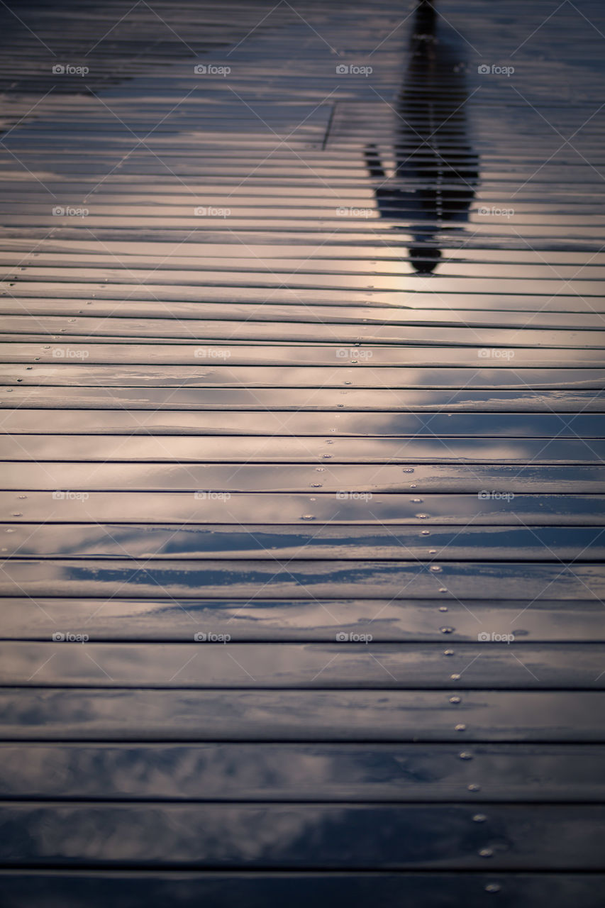 Reflection of a person on wooden planks