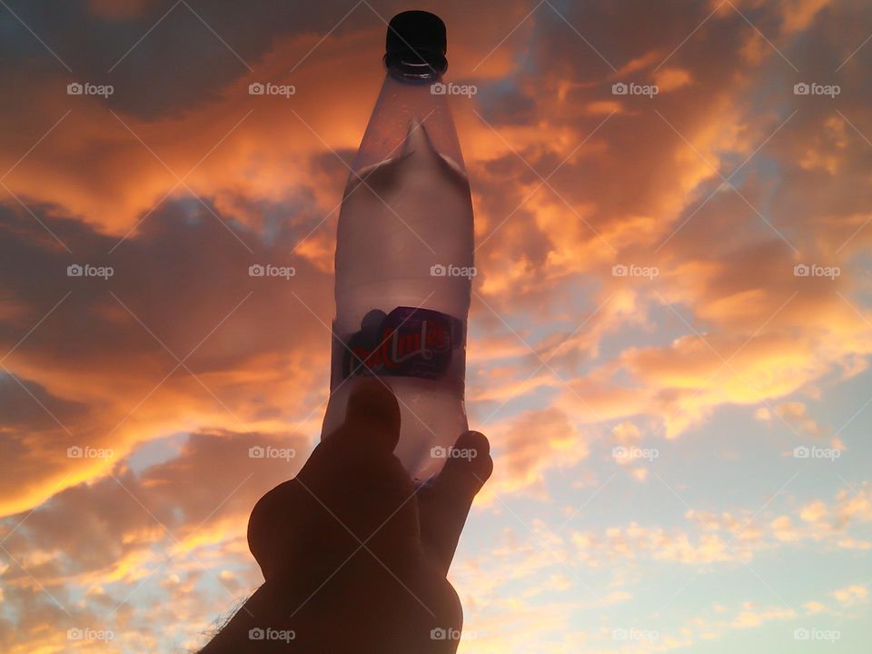 Magic sunset and a beautiful bottle embraces high sky.