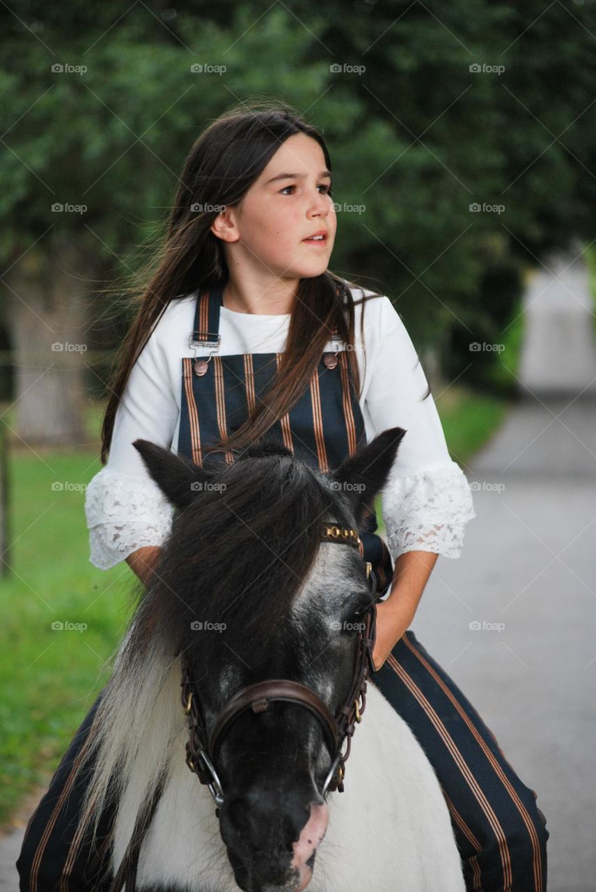 Girl with long hair on horse