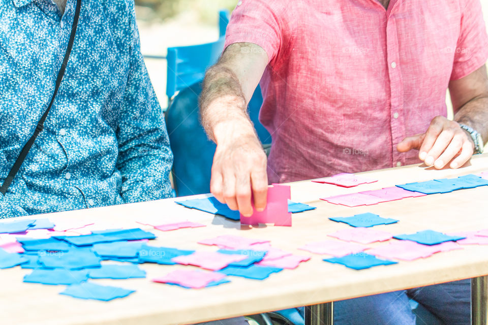 Men playing jigsaw puzzle