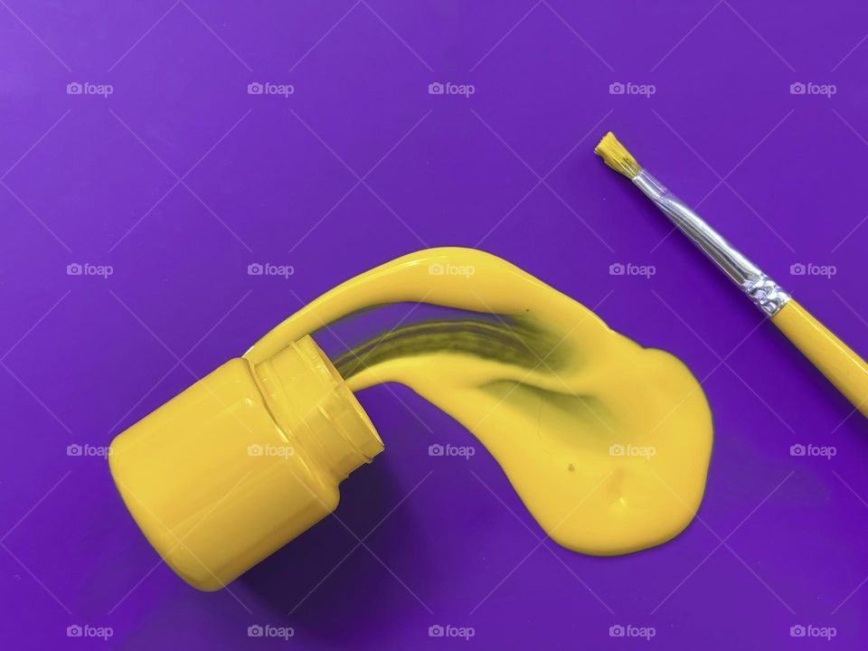 Yellow Paint Splash on Purple Background – Complementary Colors Concept