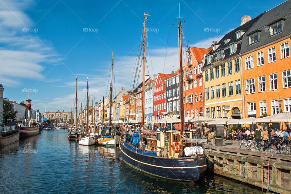 People enjoying Nyhavn in Copenhagen on a sunny day in october